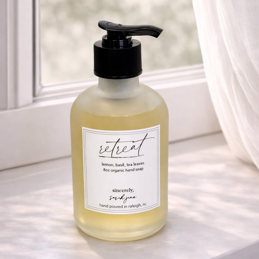Hand soap bottle with pump on a windowsill