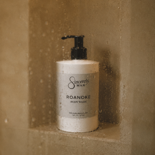 Body wash bottle labeled 'Sincerely, Man Roanoke' in a shower setting