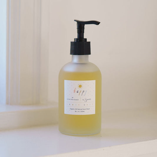 Bottle of liquid soap with pump on a white surface