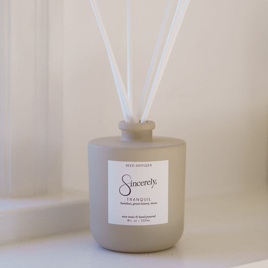Scented diffuser with reeds on a neutral background