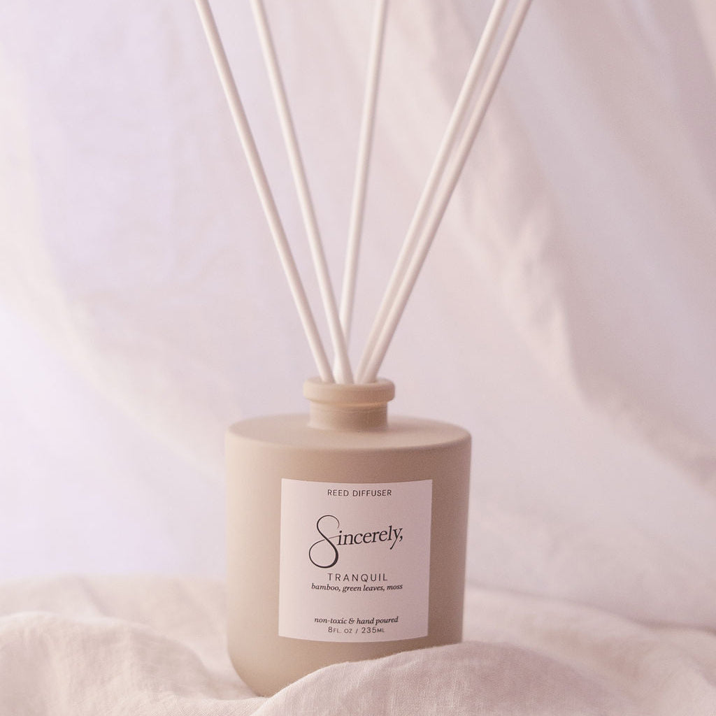 Diffuser with reeds on a soft fabric background