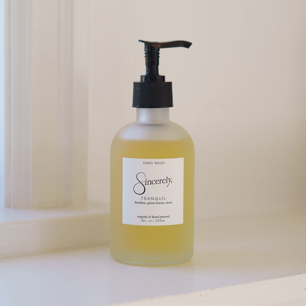 Bottle of 'Sincerely' hand soap on a white surface with a neutral background