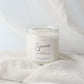 Candle labeled 'Sincerely' on a white fabric background