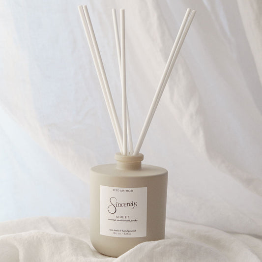 Diffuser with reeds on a soft fabric background