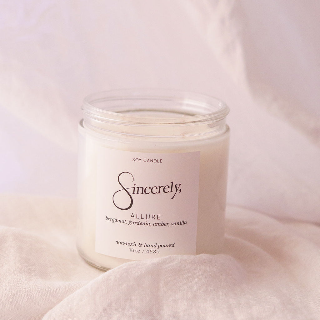 Candle labeled 'Sincerely' on a soft pink background