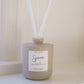 Beige diffuser bottle with white sticks on a light background