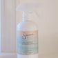 White spray bottle labeled 'Sincerely' on a white surface with a light background