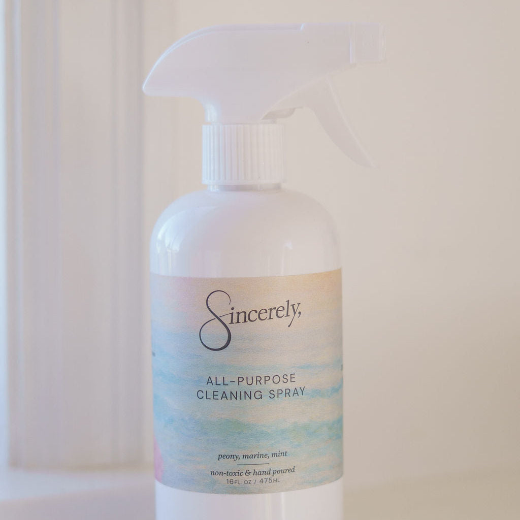 White spray bottle labeled 'Sincerely' on a white surface with a light background