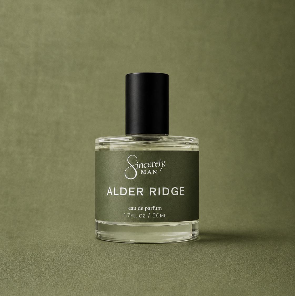 Perfume bottle labeled 'Alder Ridge' by 'Sincerely, Man' on a green background