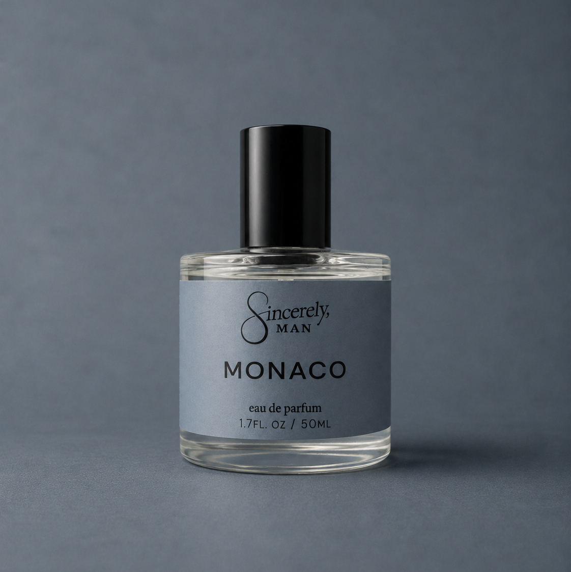 Perfume bottle labeled 'Sincerely, Man Monaco' on a gray background