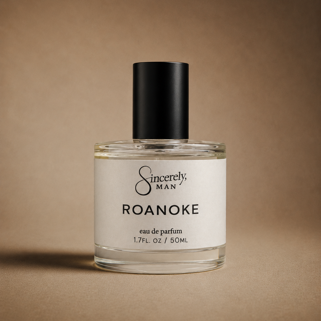 Perfume bottle labeled 'Sincerely, Man Roanoke' on a brown background