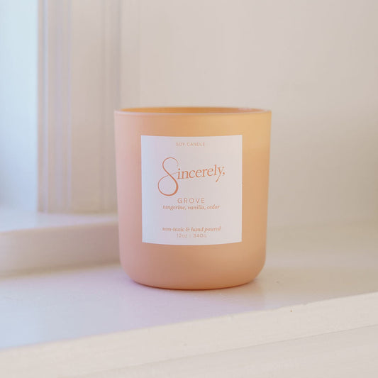 Tangerine candle with a label on a white surface