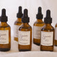 Set of brown glass bottles with dropper lids labeled 'Sincerely' on a white background.
