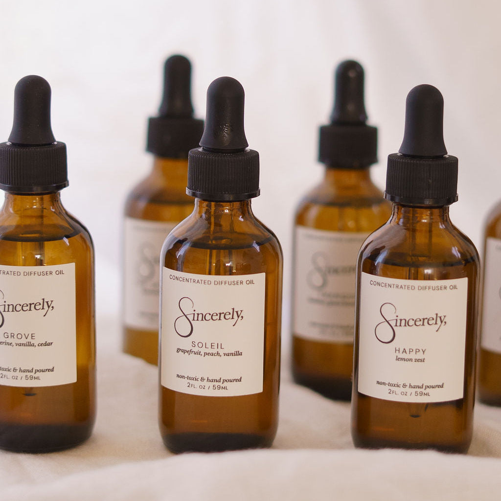 Set of brown glass bottles with dropper lids labeled 'Sincerely' on a white background.