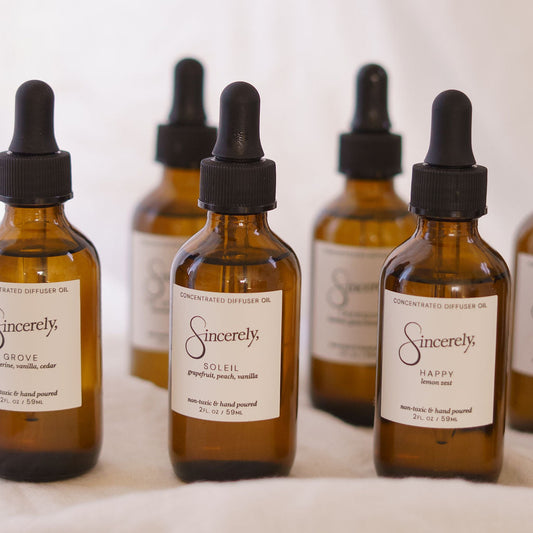 Set of brown glass bottles with dropper lids labeled 'Sincerely' on a white background.