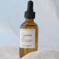 Bottle of 'Sincerely' oil with dropper on a light background