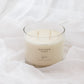 A 4-wick soy candle in a clear glass jar with cream-colored wax, labeled 'GOLDEN', set against a draped white fabric background.