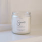Candle jar labeled 'Sincerely' on a white surface with a white background