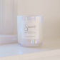 Candle with 'Sincerely' label on a white surface