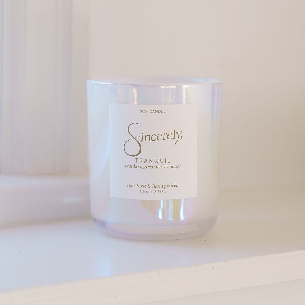Candle with 'Sincerely' label on a white surface