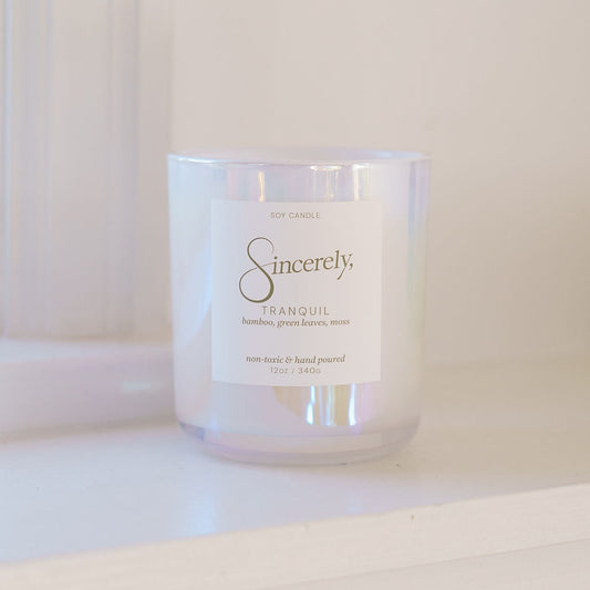 Candle with 'Sincerely' label on a white surface