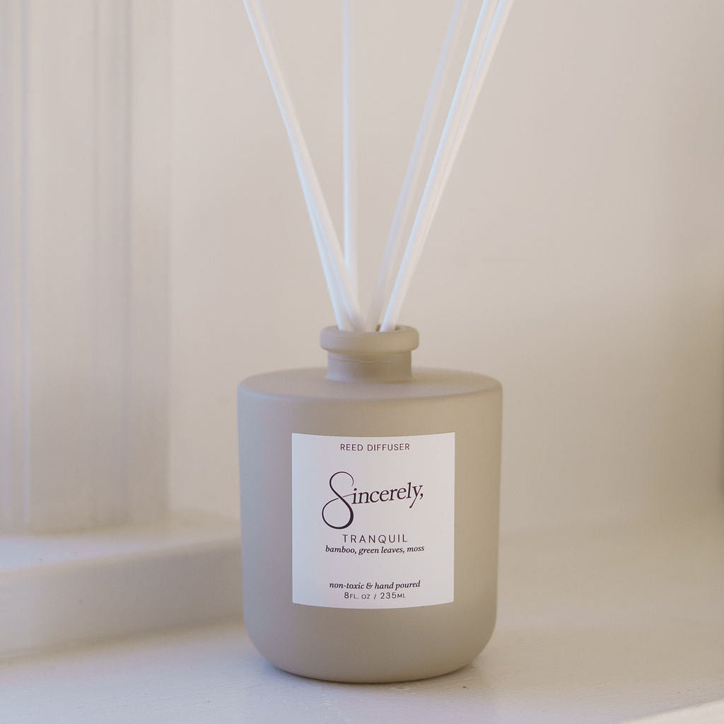 Scented diffuser with reeds on a neutral background