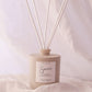 Diffuser with reeds on a soft fabric background