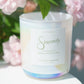 Candle labeled 'Sincerely' with pink flowers in the background