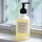 Hand soap bottle labeled 'Sincerely' on a windowsill with natural light
