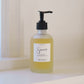 Bottle of 'Sincerely' hand soap on a white surface with a neutral background