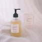 Bottle and Candle of Sincerely products on a white fabric background